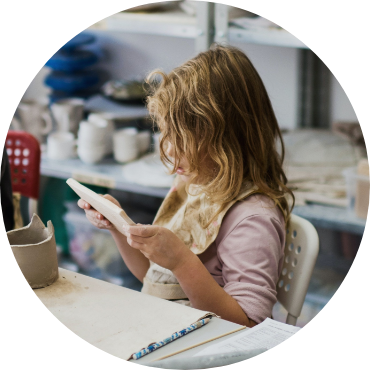 Child making art at a table